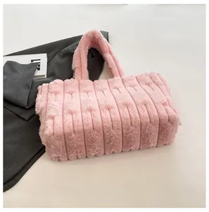 Detail of pink plush tote bag showing vertical striped texture and thick soft handles
