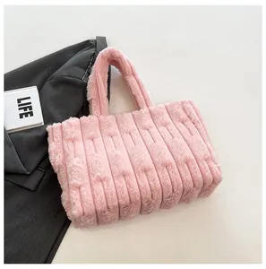 Detail of pink plush tote bag showing soft faux fur texture and vertical quilted pattern