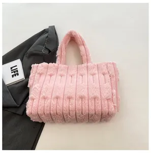 Detailed top view of pink plush tote bag with vertical stripes and soft fuzzy texture
