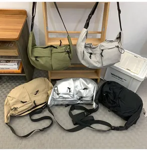 Detail view of nylon crossbody bags in five colors with multiple drawstring pockets