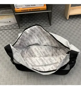 Macro view of nylon crossbody bag interior showing large capacity and zipper pocket