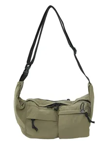 Unisex nylon crossbody bag with adjustable strap and dual front pockets in khaki green