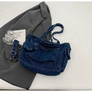 Detail of dark blue denim tote with multi-pockets and detachable round coin purse