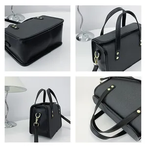 Détails du sac bandoulière en cuir noir et sergé gris avec rivets dorés élégants