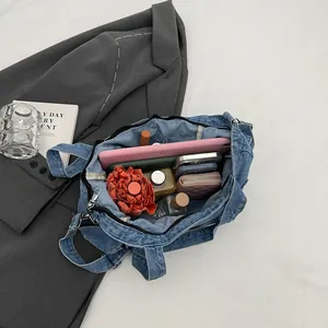 Large blue denim tote bag showing spacious interior with tablet and daily essentials