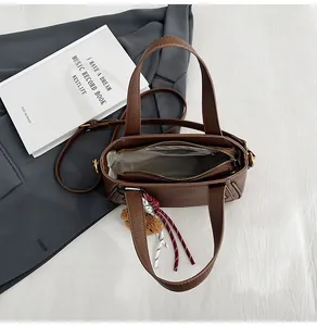 Deep brown lychee pattern leather bag interior with zipper compartment and gray lining