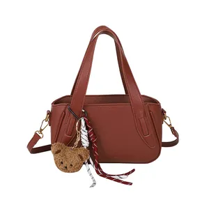 Retro brown lychee pattern handbag with cute bear charm and adjustable shoulder strap