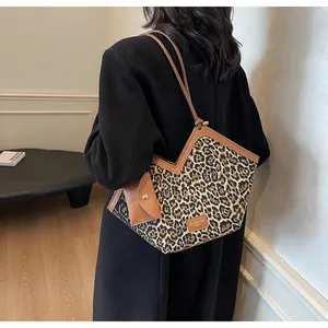 Detail der Leopard-Tragetasche mit braunem Lederbesatz und V-förmigem Öffnungsdesign