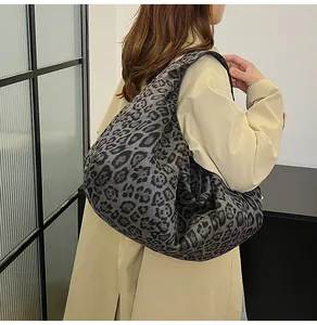 Detail shot of oversized leopard print tote bag styled with a beige trench coat