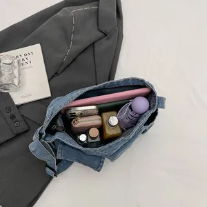 Versatile blue denim shoulder bag showing spacious interior for daily essentials storage