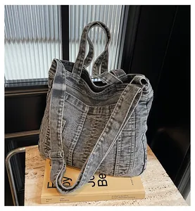 Detailed shot of retro washed denim tote with adjustable strap and metallic buckle