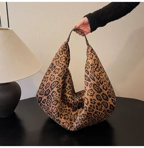 Detail of leopard print tote bag texture and soft velvet material in warm lighting