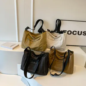 Versatile canvas messenger bags in four colors with large capacity and flap pockets