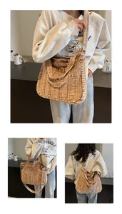 Detailed view of brown vintage denim tote bag with visible stitching and double straps