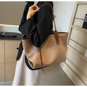 Detail of camel woven tote bag showing large capacity design and premium texture