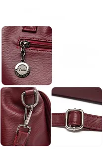 Détails des ferrures argentées et de la texture cuir grainé sur le sac bordeaux