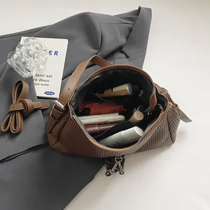 Brown retro pleated tote bag with large capacity, shown with daily essentials and strap