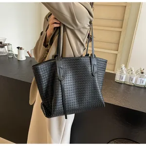 Close-up of black woven tote bag with a minimalist texture and large capacity design