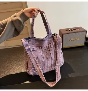 Close-up of vintage washed denim tote bag in lavender with multi-pockets and adjustable strap