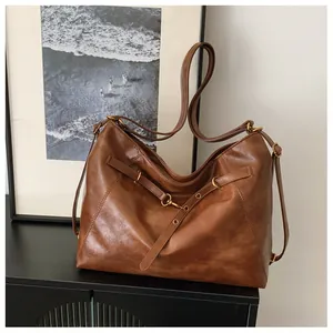 Primer plano detallado de un bolso tote marrón vintage grande con hebilla metálica fina