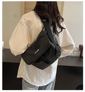 Close-up of high-density black nylon crossbody bag featuring wide strap and buckle
