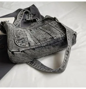 Detail of vintage washed denim tote bag showing acid wash texture and cargo pockets