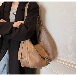 Detail of mocha brown tote bag with silver star studs on wide adjustable strap