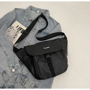 Detail of waterproof black crossbody bag with flap buckle closure and adjustable strap