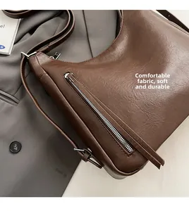 Detail of dark brown PU leather hobo bag with zip pocket and adjustable strap