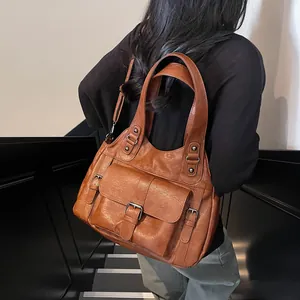 Vintage caramel brown faux leather tote bag with large front pocket and shoulder strap
