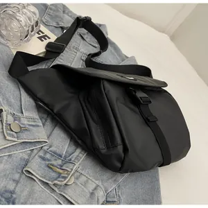 Close-up of waterproof black nylon messenger bag with buckle and adjustable strap