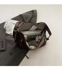 Interior view showing the large capacity and pockets of the dark brown leather tote bag