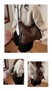 Detail of dark brown tote bag showing the lychee texture and vertical metal zipper detail