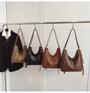 Row of large faux leather hobo bags in khaki, black, caramel and dark brown colors