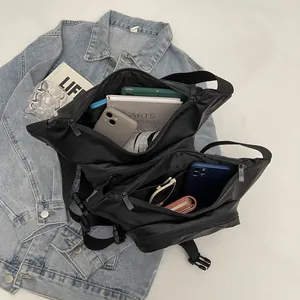 Waterproof black nylon crossbody bag with multi-pocket storage and adjustable strap