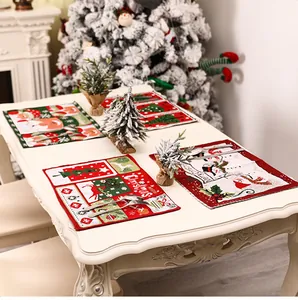 Close-up of four knitted Christmas placemats with Santa and reindeer on a dining table