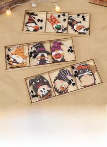 Macro detail of wooden Halloween gnome pendants with pumpkin and wizard hat elements