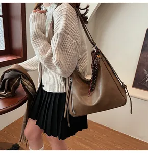 Retro brown PU hobo bag with checkered scarf detail shown on elegant model outfit