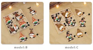 Detail of painted wooden Halloween gnomes with witch hats and pumpkin motifs in a box