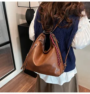 Detailed back view of vintage brown PU leather tote bag worn as a versatile backpack
