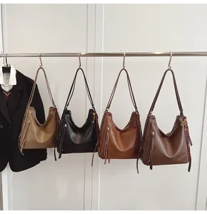 Detail view of colorful PU leather tote bags with tassels and elegant scarf accessories
