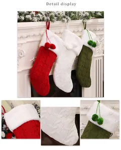Detailed view of cable knit Christmas stockings with plush faux fur trim and pom-poms