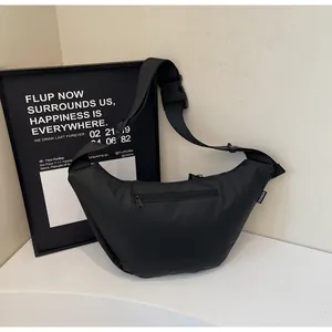 Detail of waterproof nylon crossbody bag featuring a hidden back zipper pocket