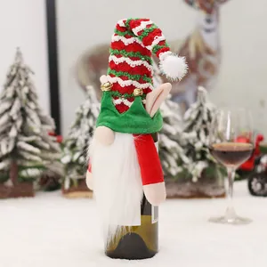 Christmas gnome wine bottle cover with red striped hat and bells for holiday table decor