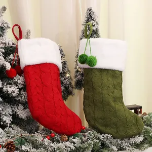 Classic red and green knitted Christmas stockings with white faux fur trim and pom-poms