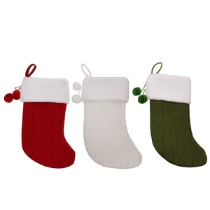 Set of 3 knitted Christmas stockings in red, white and green with faux fur and pom-poms