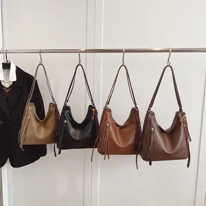 Retro PU leather tote bags in four colors hanging on a rack for work and daily use