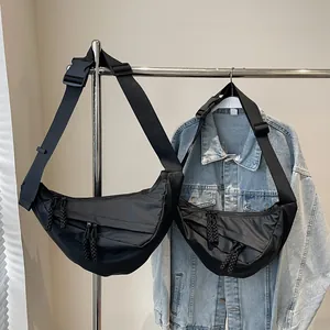 Minimalist black nylon crescent crossbody bag in two sizes with adjustable straps
