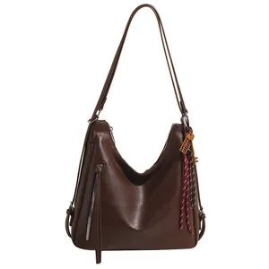 Deep brown faux leather hobo tote bag with long tassel and vintage key accessory