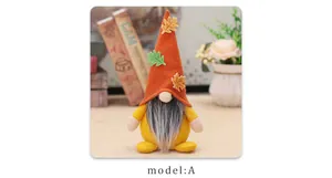 Close-up of fall gnome plush with orange pointed hat and maple leaf decor for harvest day